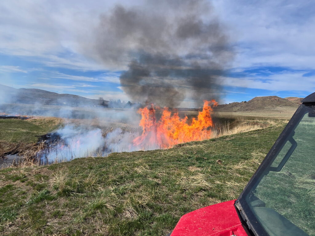 Grass fire seen from a UTV