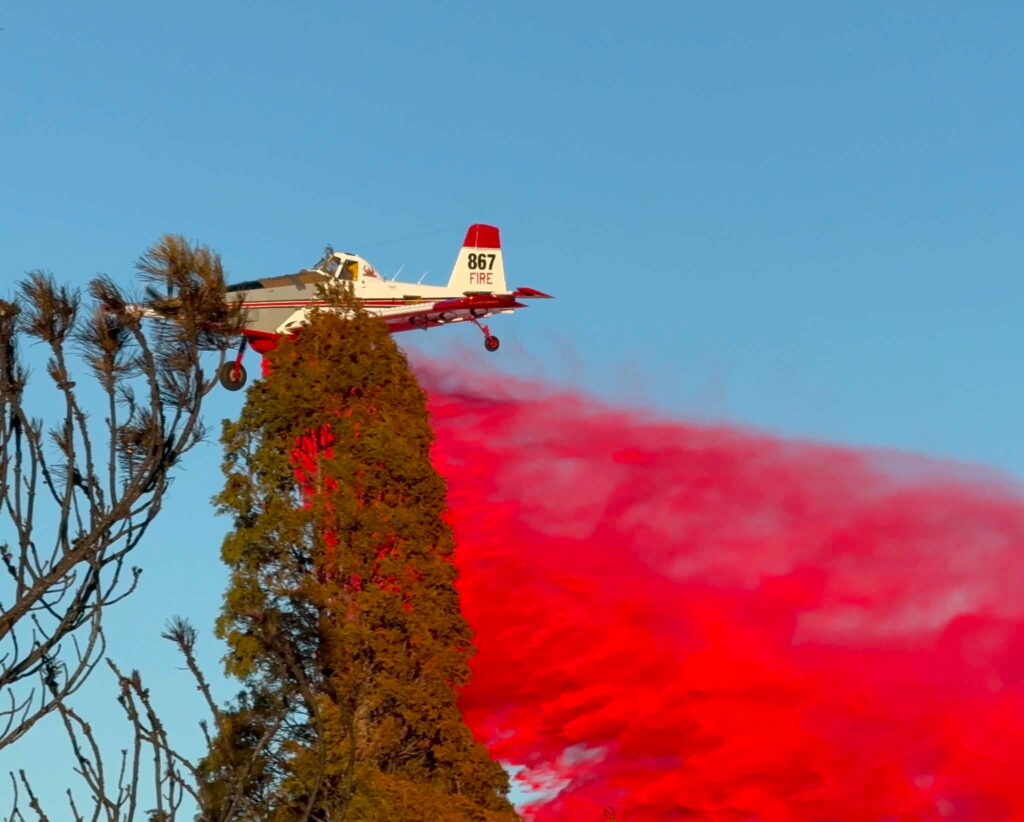 Air tanker dropping red retardant
